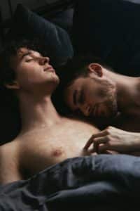 An image of an intimate same-sex couple demonstrates the joy that comes along with using penis enlargement tricks.