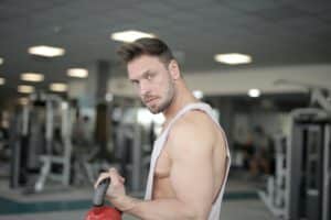 An image of a guy in a gym demonstrates a trick of how to get better in bed.