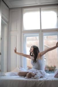 An image of a woman seated on a bed illustrates the need for her partner to get better in bed